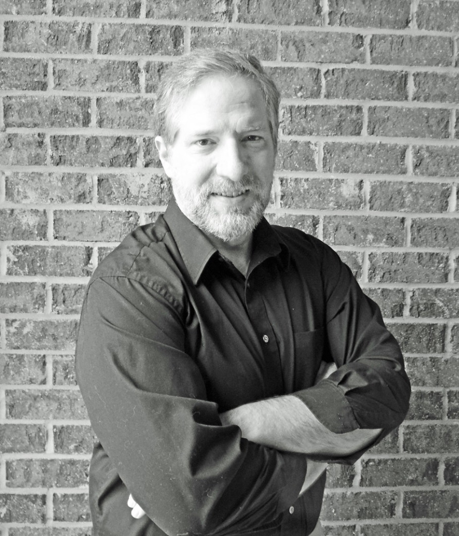 Photograph of Gary DePaul in front of a brick wall